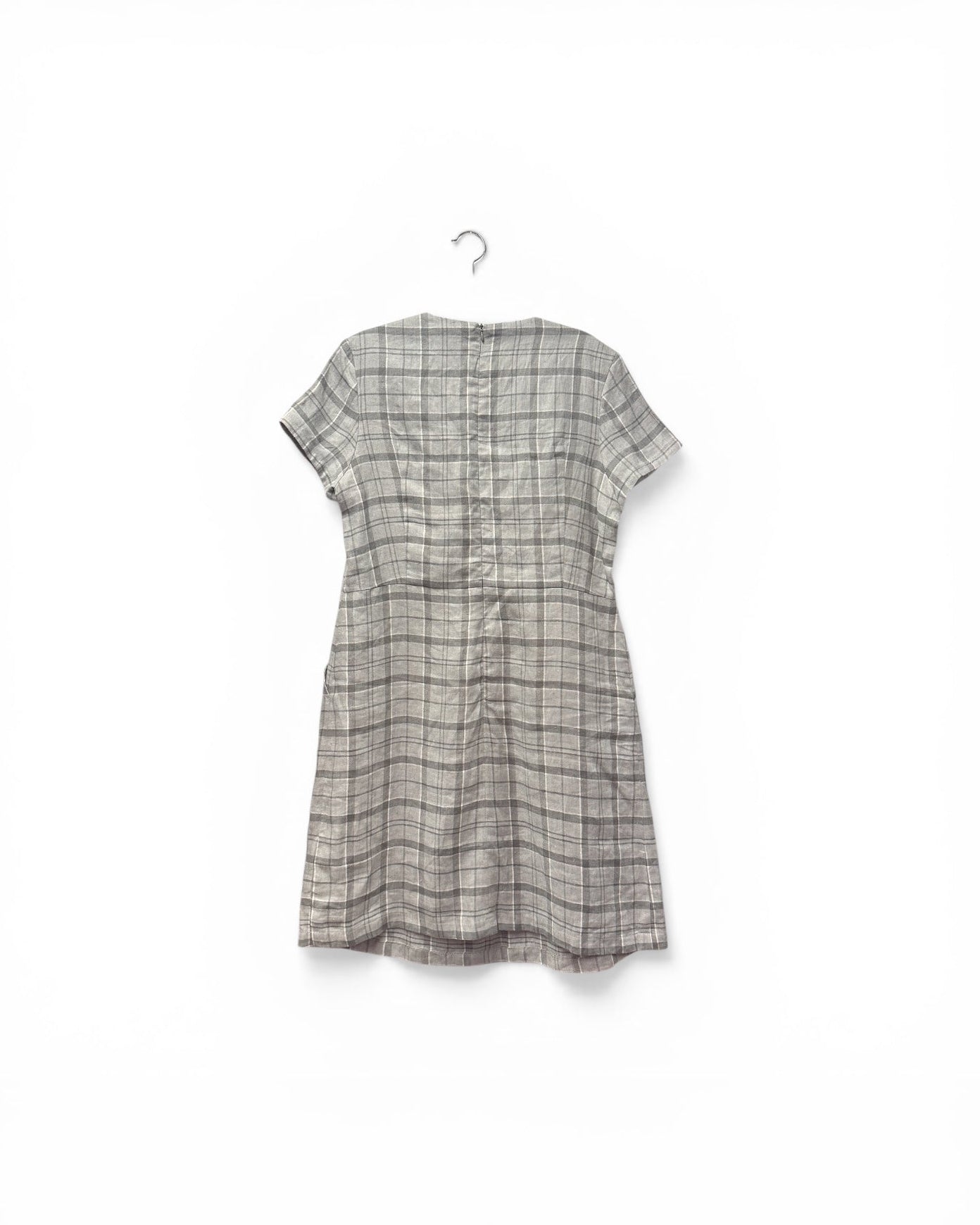 Plaid dress on a hanger against a white background