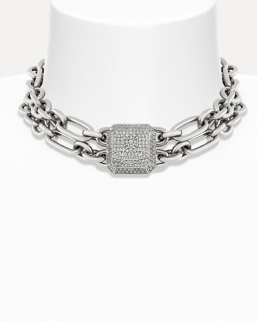 A silver-toned chain necklace with a central square link paved with small clear stones, displayed on a white mannequin bust against a white background.