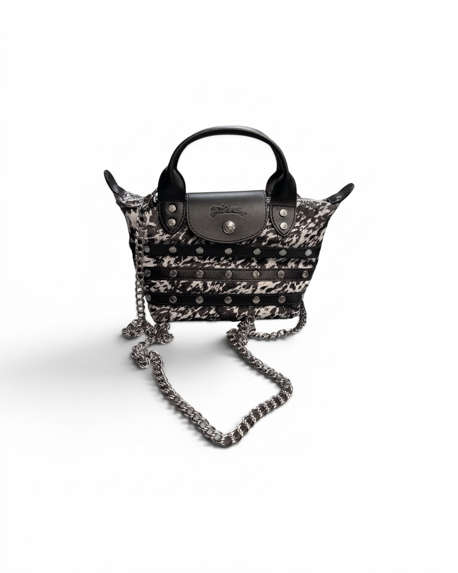 Designer handbag with chain detail on a white background