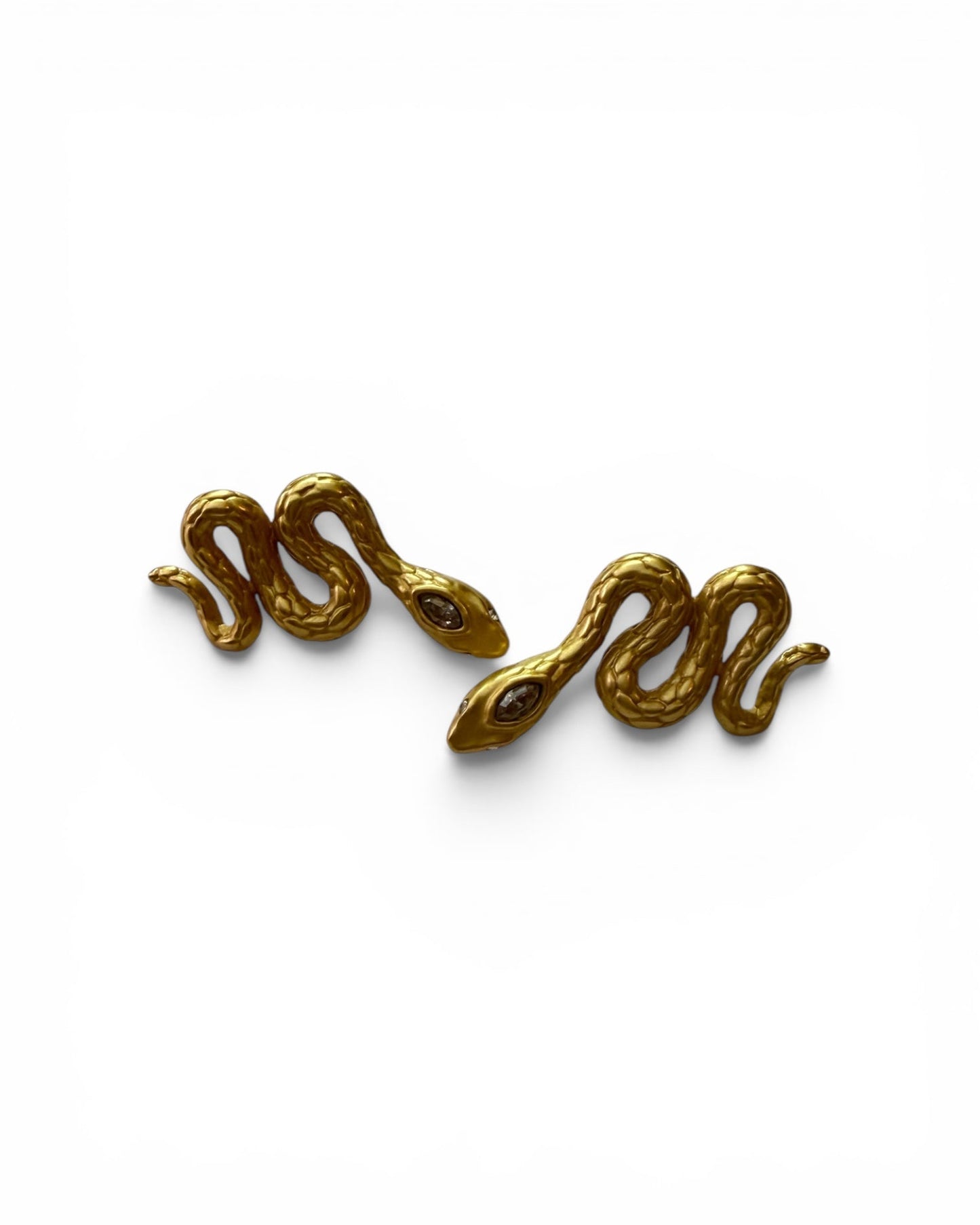 Pair of gold snake-shaped earrings on a white background
