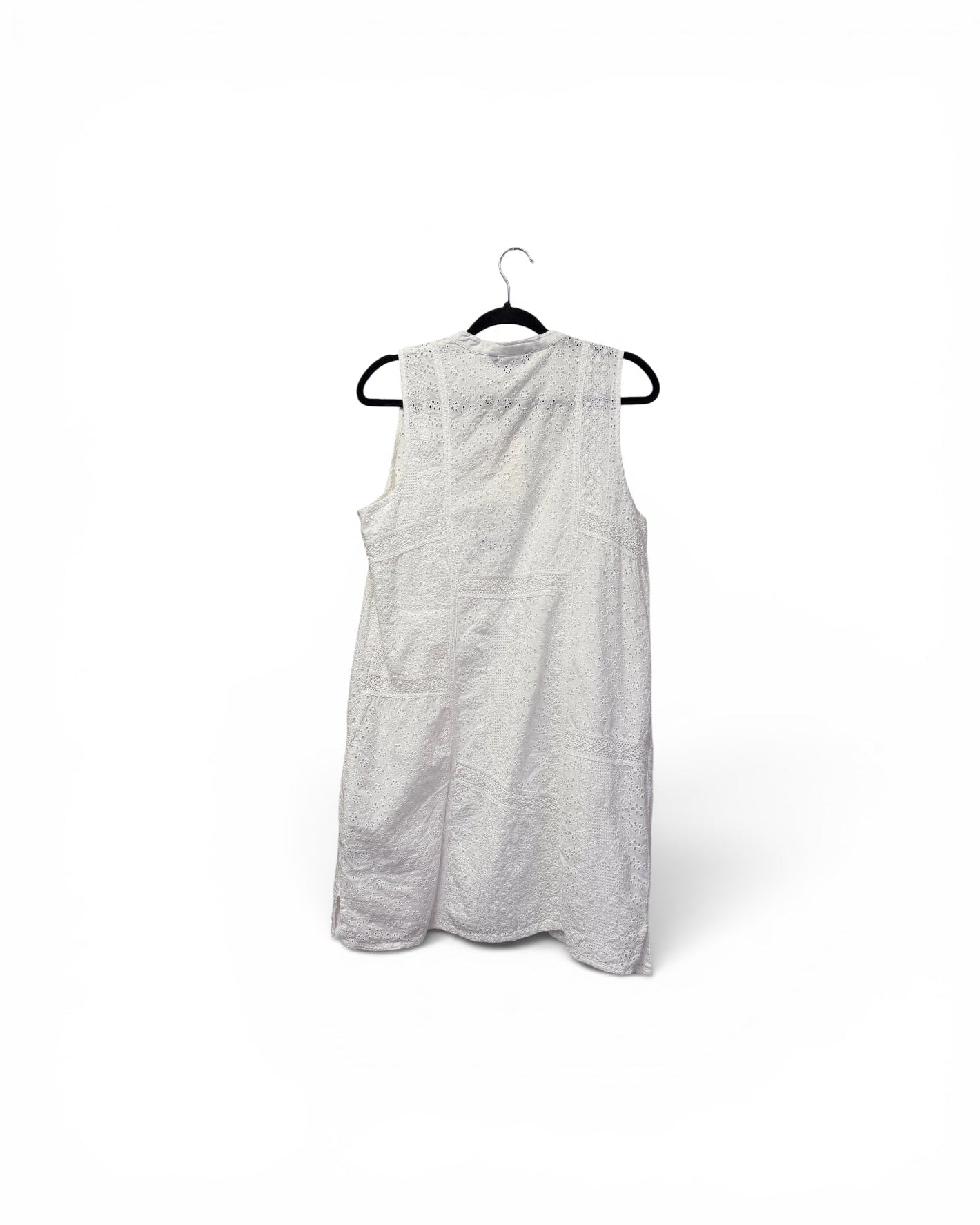 A white sleeveless dress with a textured, slightly sheer fabric, hanging on a black hanger against a plain white background.